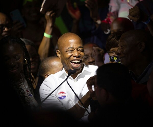 Eric Adams smiling in a crowd