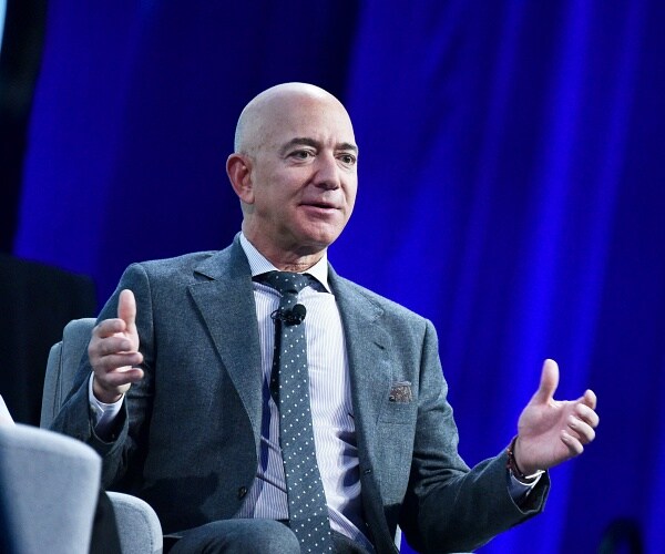 jeff bezos sits onstage