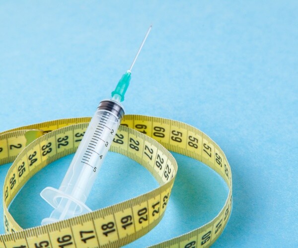 measuring tape, syringe for injecting weight-loss drug