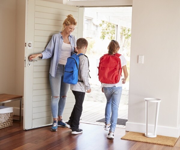 mom saying good-bye at door as kids head out to school