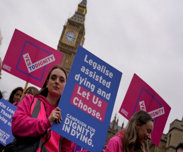 people with signs promoting legalized assisted dying