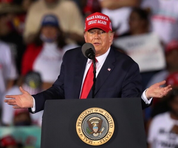 donald trump stands behind podium