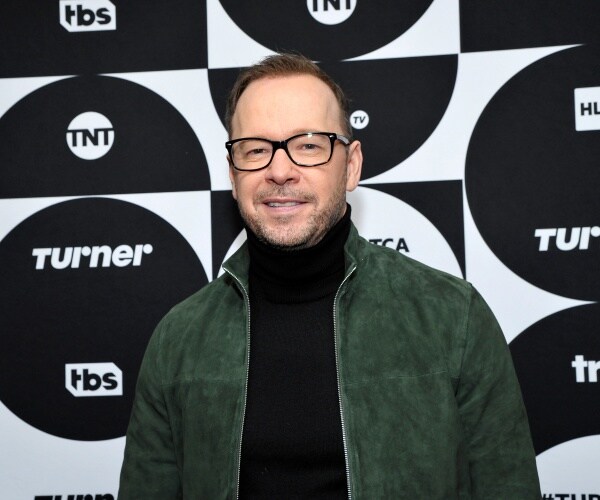 wahlberg in a black turtleneck and green jacket