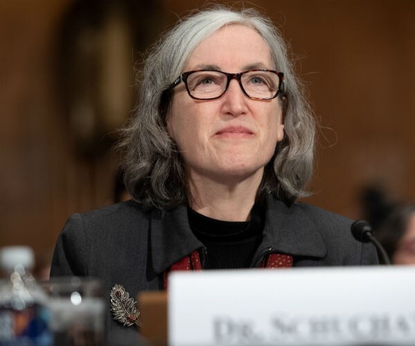 dr. anne schuchat in black and gray attire gives testimony about the coronavirus during a senate hearing