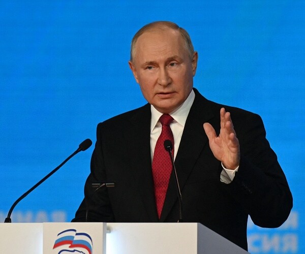 vladimir putin speaks into mic