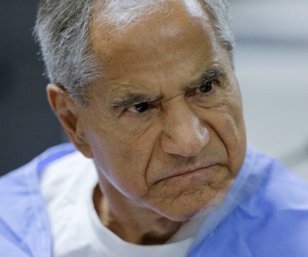 sirhan sirhan wearing prison clothes frowns during a parole hearing