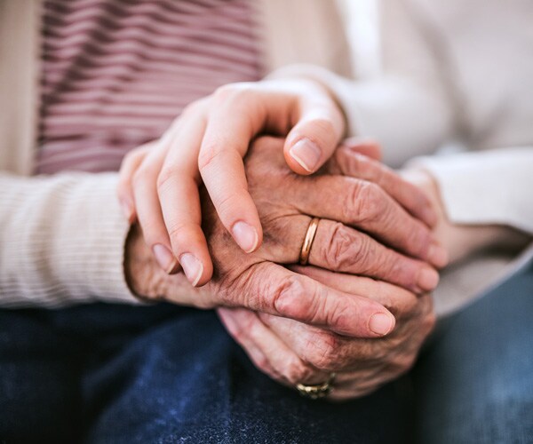 closeup of old and young hands being held