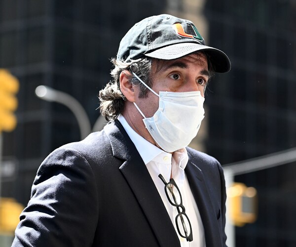 michael cohen standing and wearing a face mask