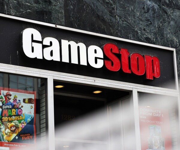 gamestop store is shown with logo and super mario poster in the window