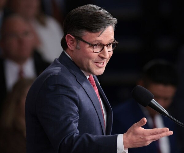 closeup of mike johnson gesturing with glasses