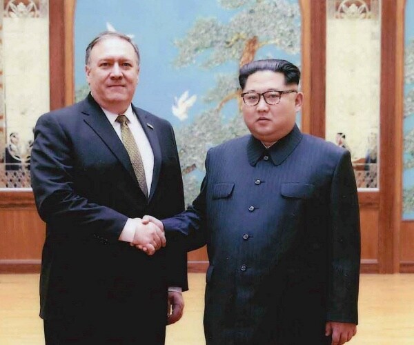 mike pompeo shakes hands with kim jong un