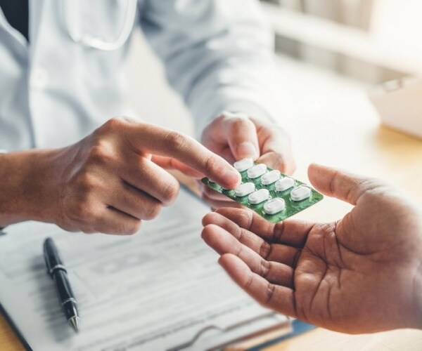 doctor handing a patient medication