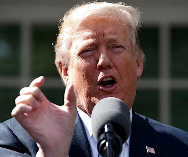 president donald trump speaks into the mic while pinching his right thumb close to his right index finger