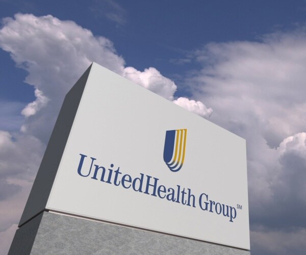 united health group logo on a board with sky in the background