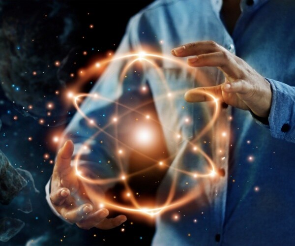 scientist holding an abstract model of nuclear fusion