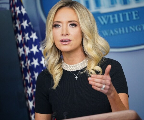 mcenany in a black top with a beaded neckline in the press briefing room