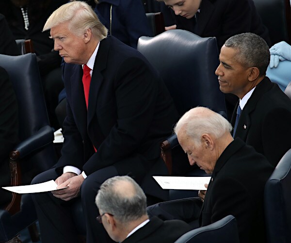 President Donald Trump sits at his inaugural, along with former President Barack Obama and Joe Biden