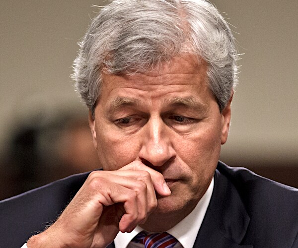 jp morgan chase chief executive officer jamie dimon bows his head into his right hand as he thinks pensively