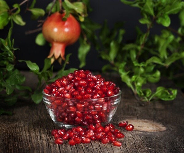 pomegranate on tree, and cut open on table