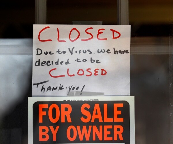 sign on window saying a business was closed and then put on sale