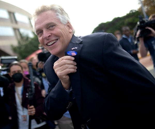 terry mcauliffe shows his i voted sticker