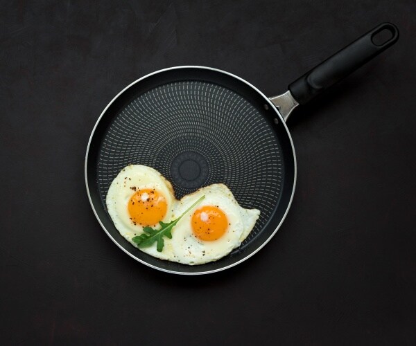 two fried eggs in a frying pan