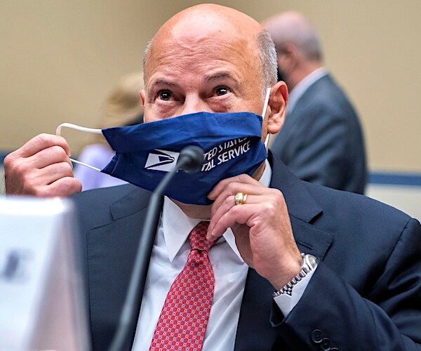 louis dejoy takes off his postal service marked face mask during a congressional hearing