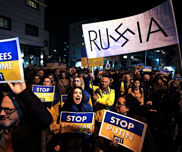 protesters in israel speak out against vladimir putin's ukraine invasion with signs of russia and nazi symbols