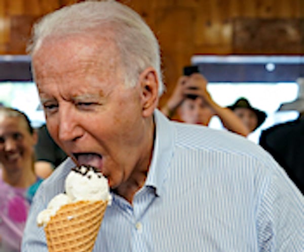 president joe biden takes a big bite of an ice cream cone