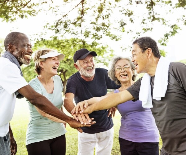 older people in a park after a workout, smiling and laughing