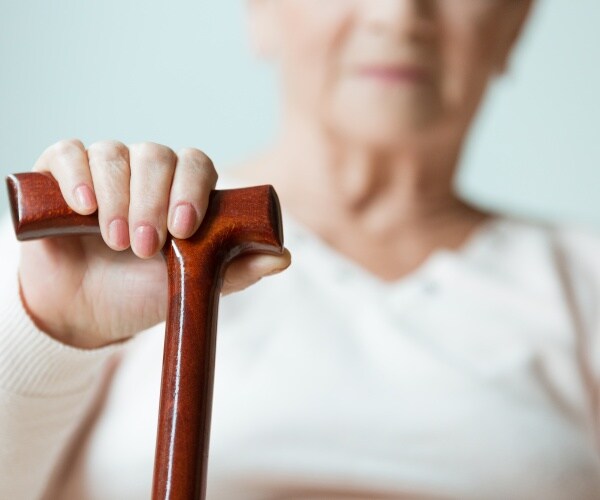 older woman holding a cane