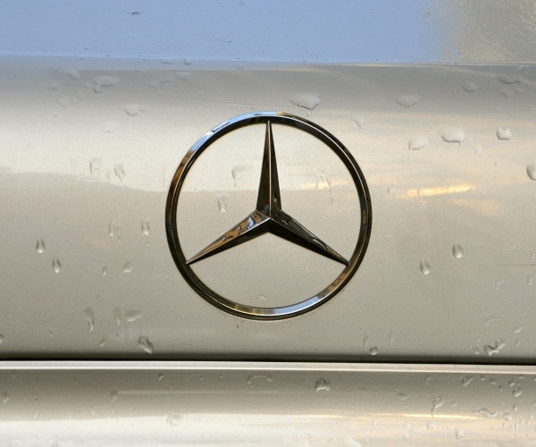 mercedes benz logo is shown on a silver car