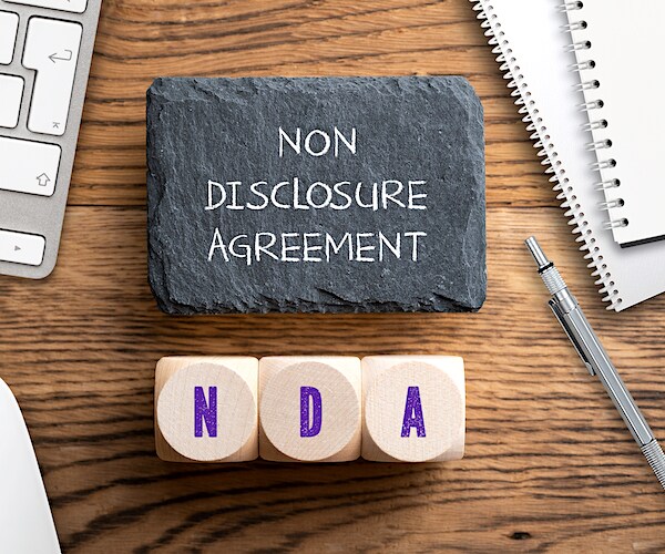 non disclosure agreement nda graphic showing scrambles tiles on a table