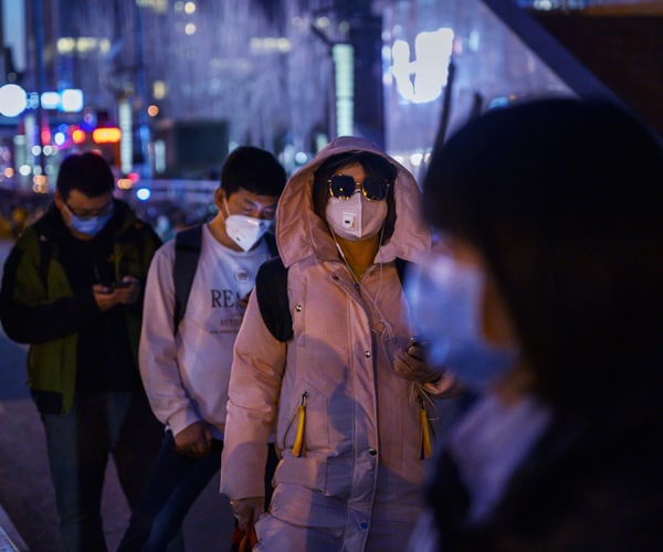 commuters in beijing wait in line for a bus