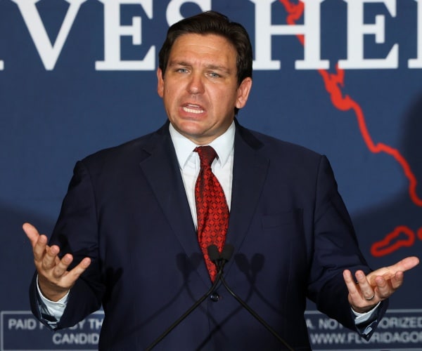 ron desantis speaks to a crowd of supporters