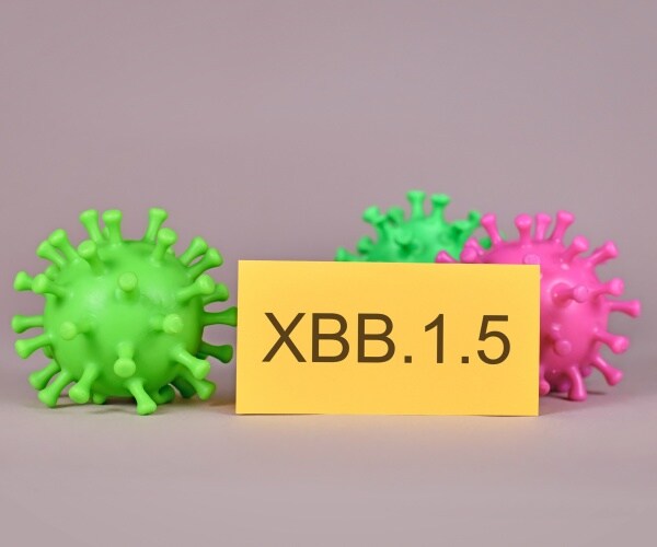 virus particles and yellow card with typed xbb.1.5 on it