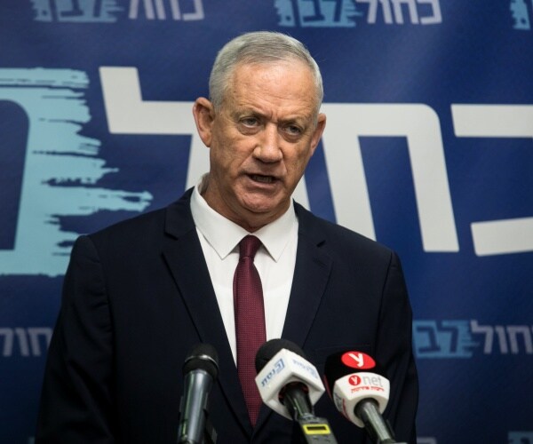 benny gantz speaks into a microphone