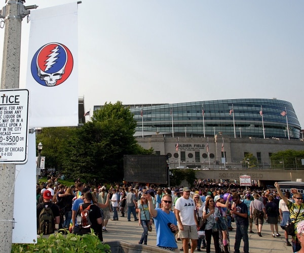 people arriving to stadium to attend concert