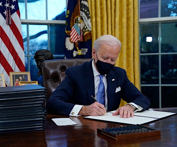 President Joe Biden signs executive orders on his first day in the Oval Office this week