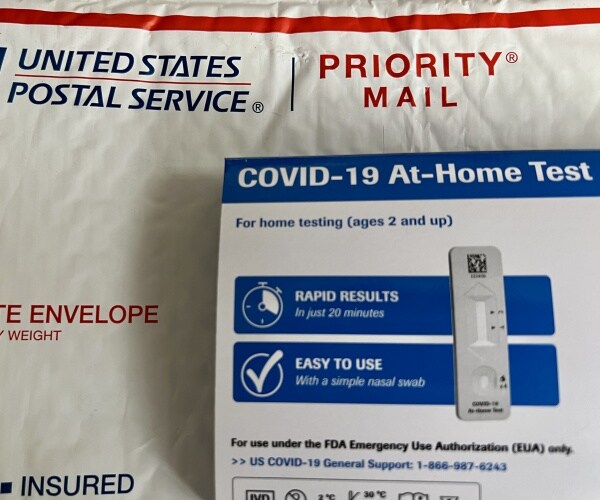 U.S. postal service envelope and free COVID-10 at-home tests