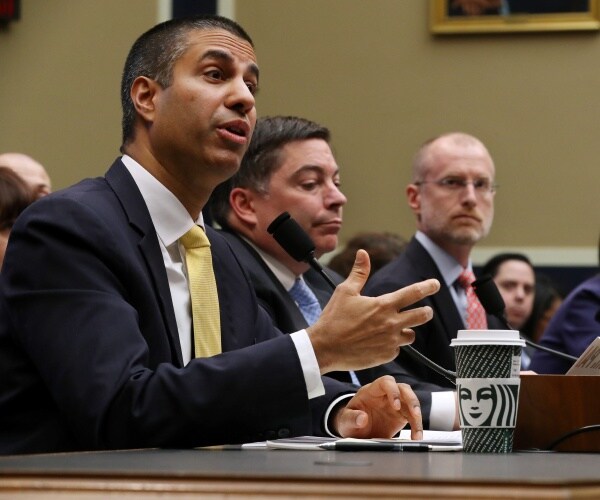 fcc testifies before a house committee with pai in a black suit and yellow tie