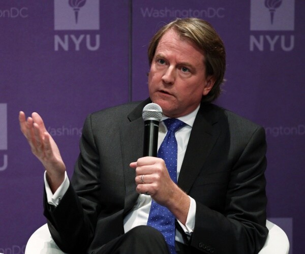 mcgahn in a suit and blue speaking at nyu