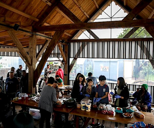 Several volunteers gather to serve food to residents during community night dinner in Austin, Texas