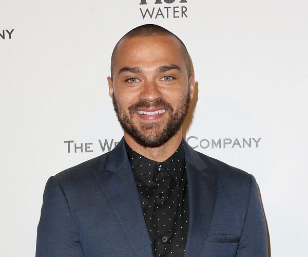 jesse williams stands on red carpet