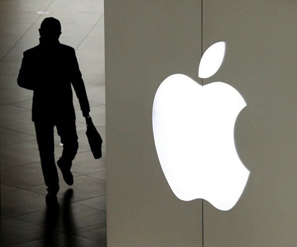 man walks out of apple store