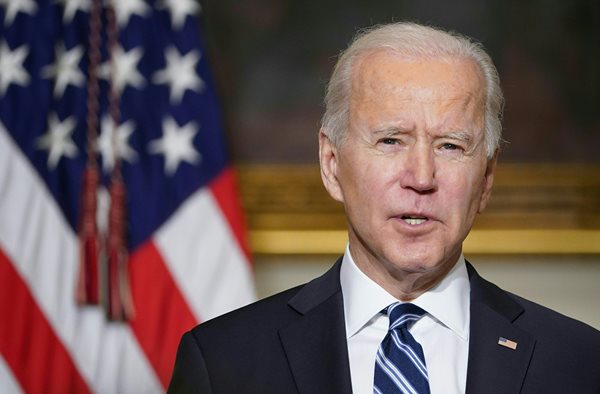 joe biden stands behind podium