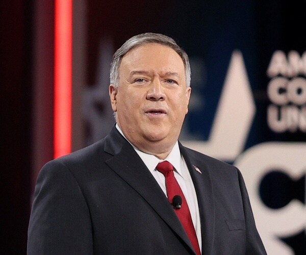 mike pompeo stands at podium on stage