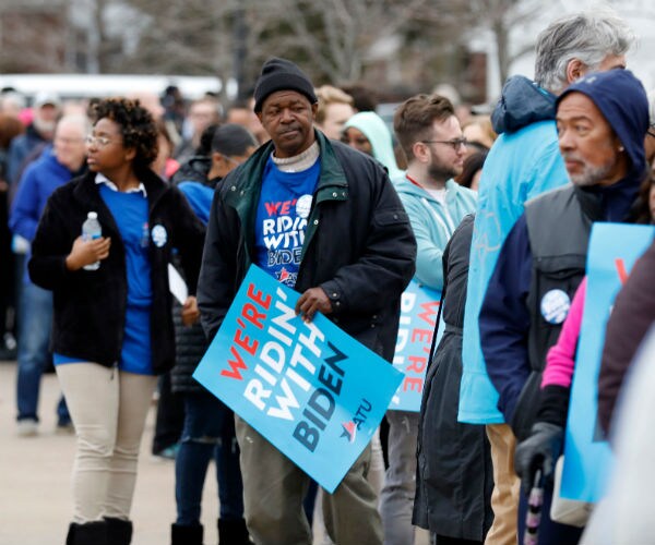 supporters of joe biden are shown in a long line