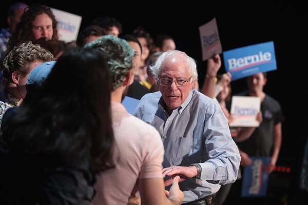 bernie sanders speaks with attendees at a townhall