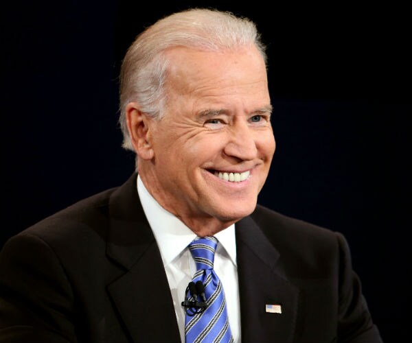 former vice president joe biden smiles wide during a conference